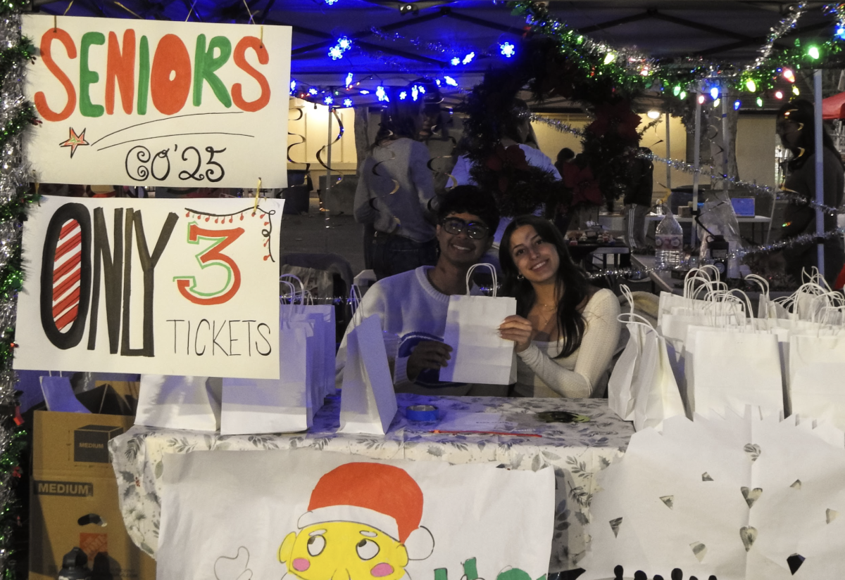 Samir Sharma('25) and Helen Santos('25) help run the Senior Stand to support this year's Seniors run their programs.